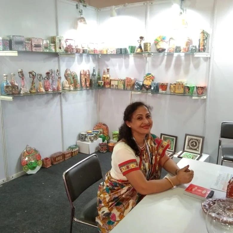 Shelves of hand-painted planters, bottles and figurines at the Srishti Green Decor exhibition stall.