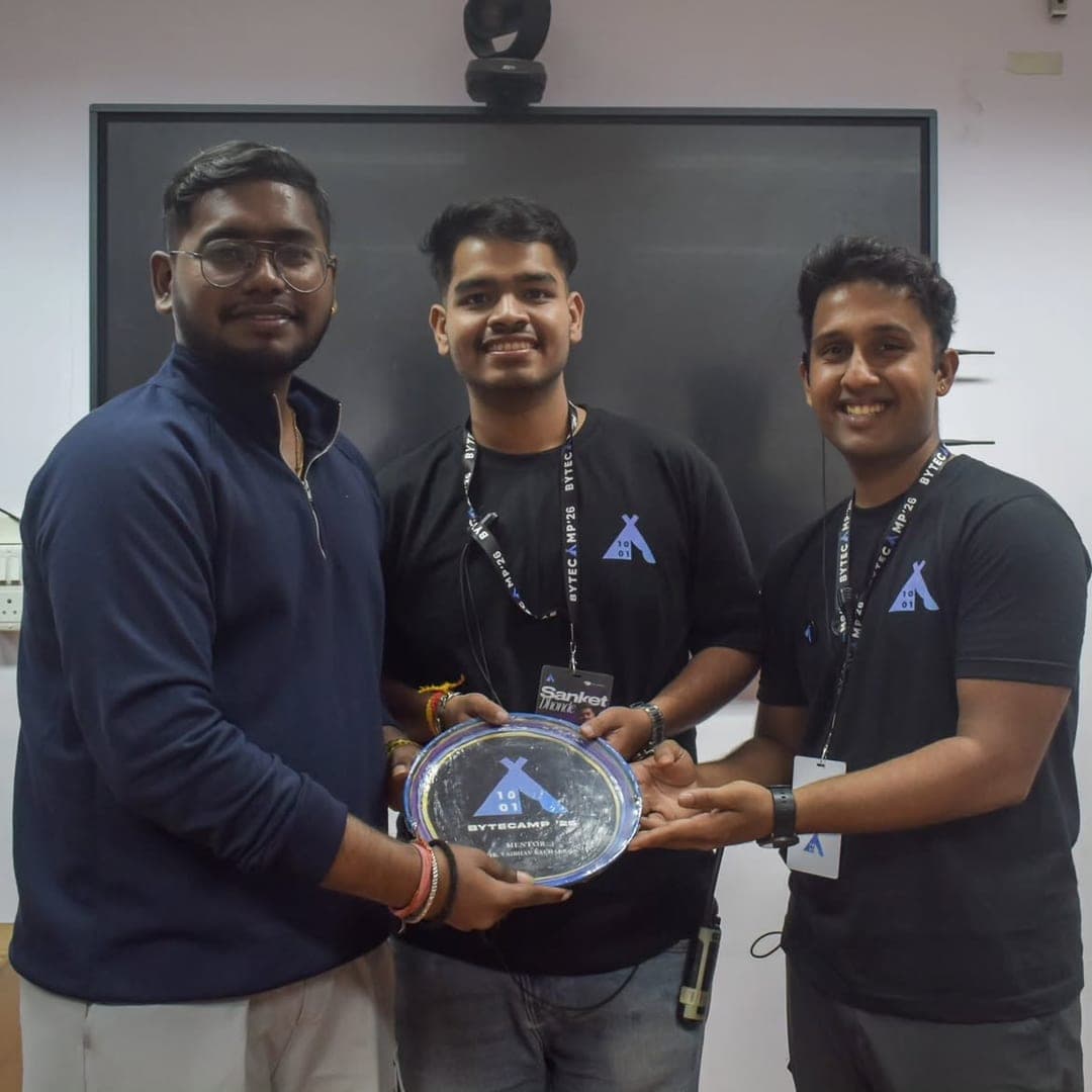 Three organisers holding a hand-painted wall plate presented to a mentor.